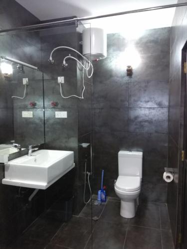 a bathroom with a sink and a toilet and a shower at Eldorado Apartments 3BR Apart F2P3 in Wattala