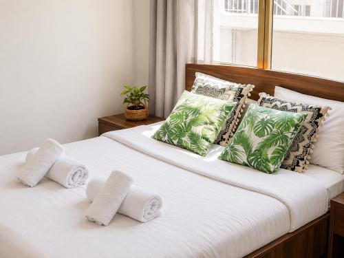 a bedroom with two beds with towels on them at Oasis - Cosy Studio in Larnaca in Larnaca