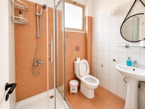 a bathroom with a shower and a toilet and a sink at Oasis - Cosy Studio in Larnaca in Larnaca