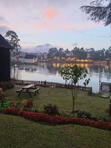 a park bench sitting next to a lake at Bliss 10 people in Palayangan