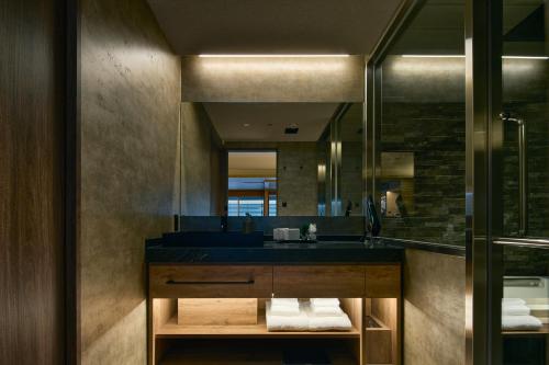 a bathroom with a sink and a mirror at Gion Kuromatsu in Kyoto