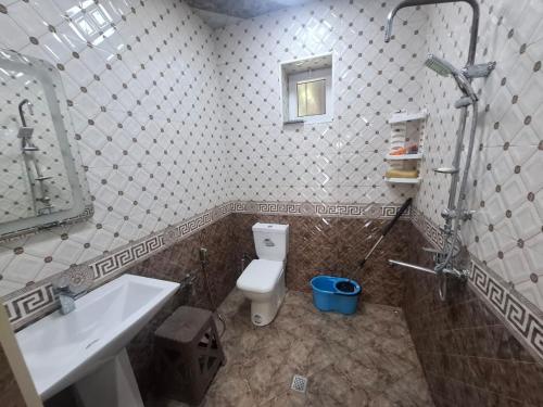 a bathroom with a toilet and a sink and a shower at dlb VILLA 2 in Baku