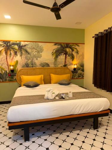 a bedroom with a large bed with yellow walls at David Residency in Madurai