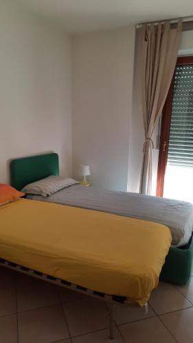 a large bed in a room with a window at CentroMare in Cattolica