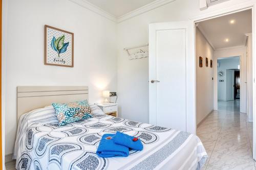 a bedroom with a bed with a blue bag on it at The Triplets in Agres