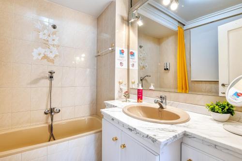a bathroom with a sink and a shower and a tub at The Triplets in Agres