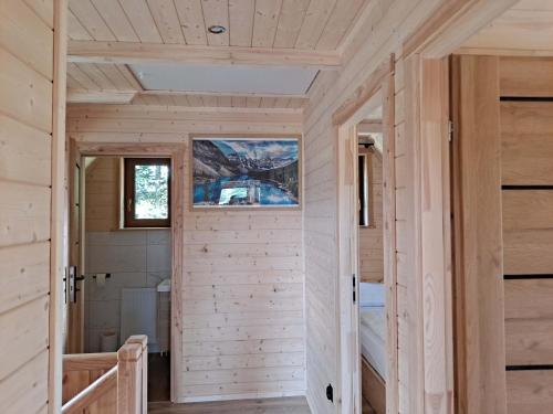 a wooden cabin with a door and a window at Domek Góralski Zębianski Dworek in Ząb