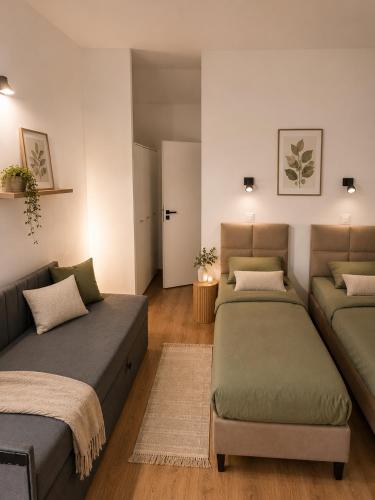 a living room with two beds and a couch at Gościniec u Bernackich in Smołdzino