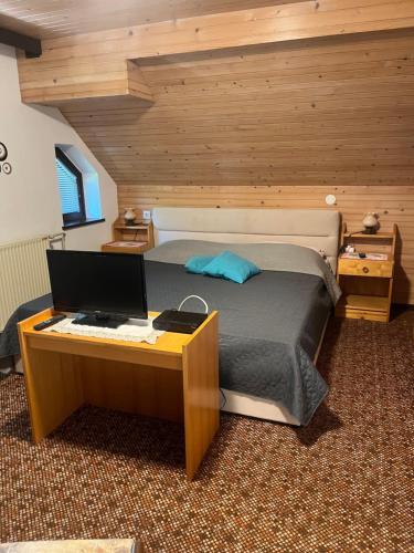 a bedroom with a bed and a desk with a computer at Apartment Cvetek Janez in Bohinj