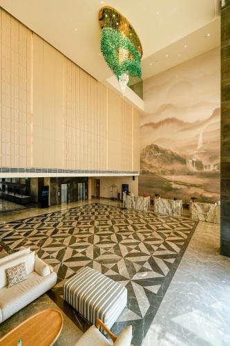a lobby with a checkered floor and a chandelier at ACASA Collective in Aurangabad