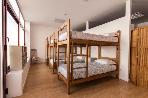 a group of bunk beds in a room at Hostel D'Avenida in Vila Praia de Âncora