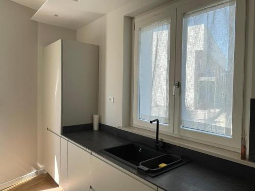 a kitchen with a sink and two windows at Villa Miranda RELAX in Ortona