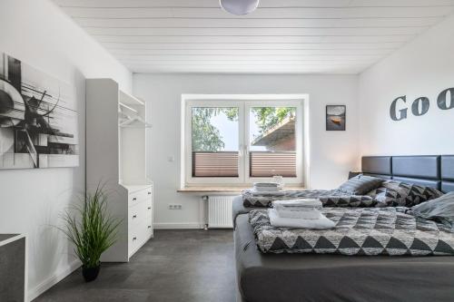 a bedroom with two beds and a window at Fewo Freiraum mit großer Terrasse in Friedrichskoog