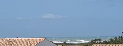 a view of the ocean from a house at Finn Lodge in Saint-Denis-dʼOléron