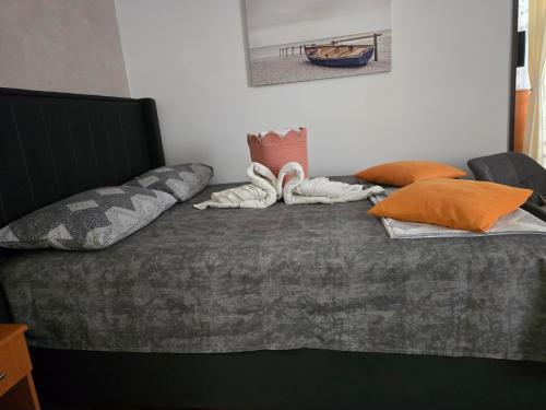 a bed with pillows on it in a room at Apartman Katarina in Sutomore