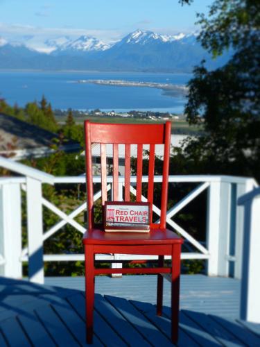 a red chair sitting on a porch with a box on it at Halcyon Heights B&B/Inn in Homer