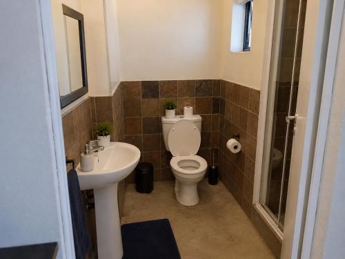 a bathroom with a toilet and a sink at Staynrestapartment in Nelspruit