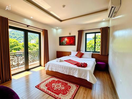 a bedroom with a bed and a large window at New Conson Hotel in Con Dao