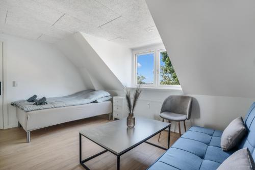 a living room with a couch and a table at Modernized Bed & Bath in Holstebro