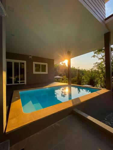 a swimming pool in the backyard of a house at Hornbill Pool Villas 1 in Ko Chang