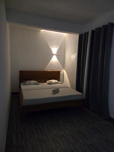 a bedroom with a bed with a light on it at The Palms Property in Long Mountain