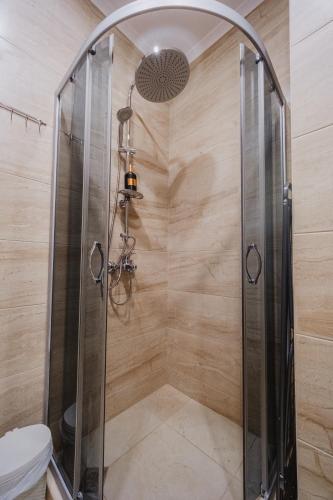 a shower stall with a glass door in a bathroom at Seafront Apartment with Panoramic Terrace in Golden Sands