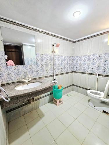 a bathroom with a sink and a toilet at Royal Villa in Karachi