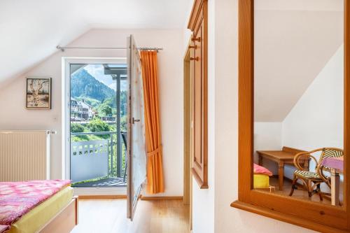 a bedroom with a view of a balcony at Gästehaus Ursula in Hornberg