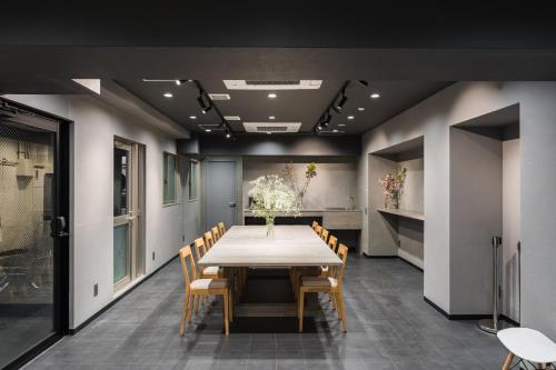 a dining room with a table and chairs at MAIDO - Doyanen Hotels in Osaka