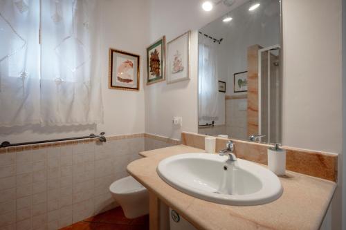 a bathroom with a sink and a toilet at B&B A Casa Di Gina in Polignano a Mare