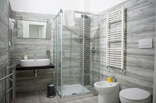 a bathroom with a shower and a toilet and a sink at Bed & Breakfast Ellenica in Rionero in Vulture