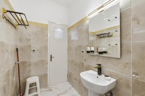 a bathroom with a sink and a mirror and a shower at Mermaids By The Sea in Mesongi