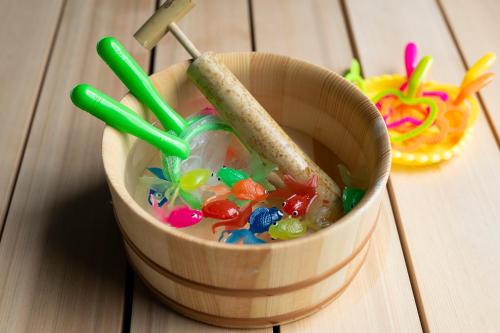 a wooden bucket filled with beads and toys on a table at soyo-ka kyoto sanjo in Kyoto
