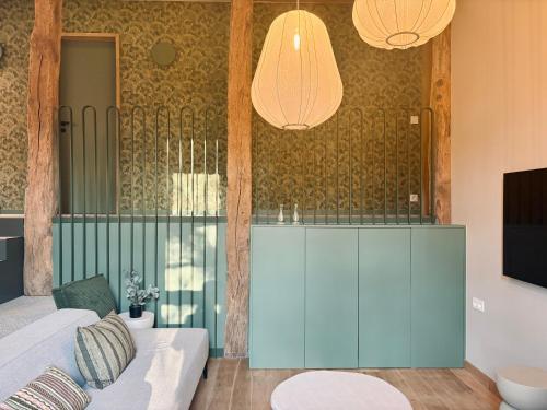 a living room with a blue cabinet and two lights at Entre Pierres et Rivière - 2 Gites avec wellness privatifs in Hotton