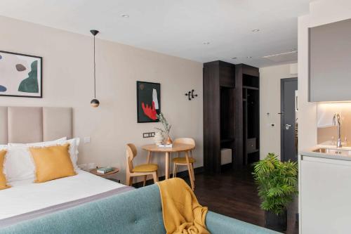 a hotel room with a bed and a table at COVE Cannon Street in London