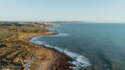 an aerial view of the ocean and a beach at oceanHUTS Coxos Adults Only from age 14 in Ericeira