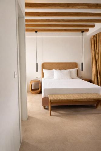 a bedroom with a large bed and a wooden ceiling at REYA suites in Aliki