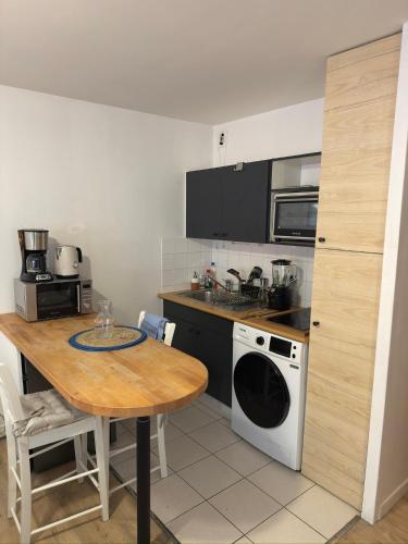 a kitchen with a table and a stove top oven at Studio Centre-ville de Vannes in Vannes