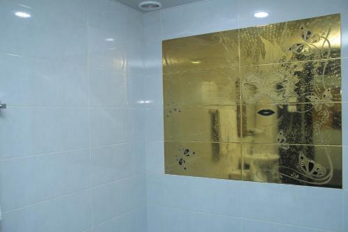 a bathroom with a shower with a glass wall at Mirage Hotel in Yerevan
