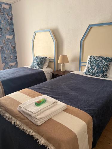 a hotel room with two beds with towels on them at Casa dos Tios- Estremoz in Estremoz