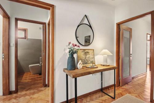 a room with a table with a mirror on the wall at Driftwood - Refúgio Perto do Mar in Matosinhos