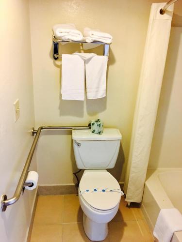 a small bathroom with a toilet and towels at Travelodge by Wyndham Reno in Reno
