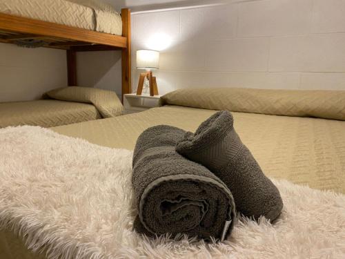 a towel is laying on a bed in a bedroom at Hotel Lobo de Mar in Mar del Plata