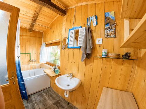 a wooden bathroom with a sink and a bath tub at Ćićkova Čarda in Ulcinj