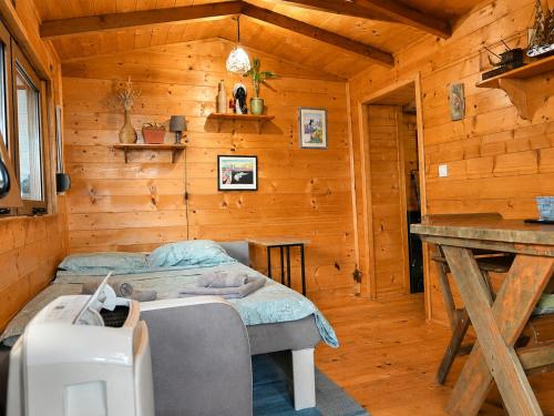 a bedroom with a bed in a wooden cabin at Ćićkova Čarda in Ulcinj