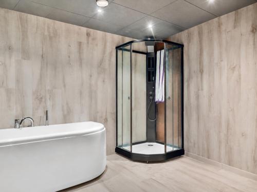 a bathroom with a shower and a white bath tub at Superior Villa with Superb View in Gravdal