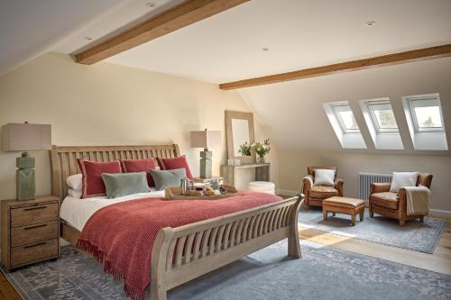 a bedroom with a large bed with red pillows at Rosehaven House at Pudleston Court in Docklow