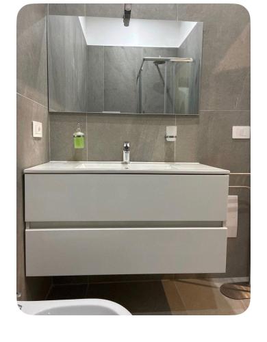 a bathroom with a white sink and a mirror at Sanleucio SILK ROOM in Caserta