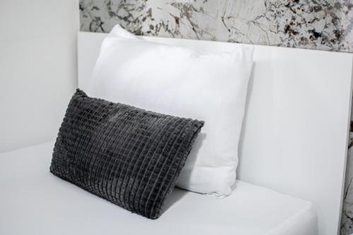 a white couch with a pillow on it at Motel Nova in Strumica