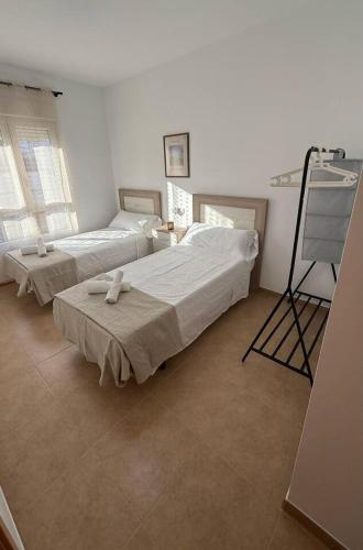a bedroom with two beds and a tripod in it at Exclusivo Adosado Jalance in Jalance